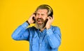 I like it so much. brutal hipster wear earphone. singing and dancing. Enjoying favorite music. Man listen music with his Royalty Free Stock Photo