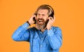 i like it so much. brutal hipster wear earphone. singing and dancing. Enjoying favorite music. Man listen music with his Royalty Free Stock Photo