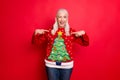 I like my jumper concept. Photo of blinking grey-haired positive hinting cheerful nice granny showing you her best with