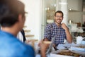 I like where youre going with this. a group of colleagues eating while having a meeting in the boardroom.