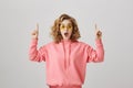 I literally can not speak from surprise. Studio shot of emotive good-looking ordinary girl with frizzle hairstyle