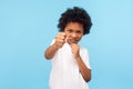 I`ll knock out you! Portrait of aggressive little boy with curly hair holding clenched fists up to attack