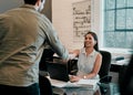 I look forward to doing business with you. two young businesspeople shaking hands in an office. Royalty Free Stock Photo