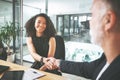 I look forward to working with you. two businesspeople sitting together and shaking hands during a meeting in the office Royalty Free Stock Photo