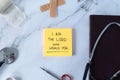 I am the LORD who heals you, handwritten text verse on note with medical tools and holy bible book Royalty Free Stock Photo