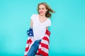 I love America. Happy young smiling woman in jeans and white Tshirt holding American flag and looking at camera. Royalty Free Stock Photo