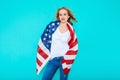 I love America. Happy young smiling woman in jeans and white Tshirt holding American flag and looking at camera. Royalty Free Stock Photo