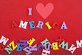 I love America word on red background composed from colorful abc alphabet block wooden letters, copy space for ad text