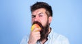 I love apples Man handsome hipster with long beard eating apple. Hipster hungry bites juicy ripe apple. Man diet