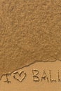 I love Bali - phrase written by hand on the beach with soft waves. Travel. Royalty Free Stock Photo