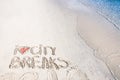 I Love City Breaks message written on sand, vacation concept, color filter applied