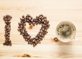 I love coffee, beans and a cup on the wooden table Royalty Free Stock Photo