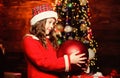 I love decorating christmas tree. Festive atmosphere christmas day. Girl santa claus costume hold big ball christmas Royalty Free Stock Photo