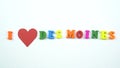 I love Des Moines. Text from colorful wooden letters and a beating paper red heart.