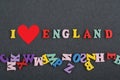 I love ENGLAND word on black board background composed from colorful abc alphabet block wooden letters, copy space for