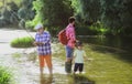 I love fishing. Senior man fishing with son and grandson. Grandfather, father and son are fly fishing on river. Royalty Free Stock Photo