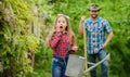 I love flowers. ecology. Watering can and shovel. little girl and happy man dad. earth day. spring village country Royalty Free Stock Photo