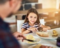 I love having breakfast with dad. an adorable little girl having breakfast with her father in the kitchen. Royalty Free Stock Photo
