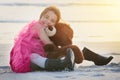 I love my bear. Portrait of a cute little girl playing with her teddy bear on the beach. Royalty Free Stock Photo