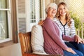 I love it when my daughter visits. Cropped portrait of a senior woman sitting outside with her adult daughter. Royalty Free Stock Photo