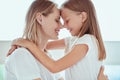 I love my mom. Happy Mothers Day. Beautiful mom with her little cute daughter are having fun at home. Hugging and kissing each Royalty Free Stock Photo