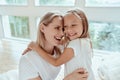 I love my mom. Happy Mothers Day. Beautiful mom with her little cute daughter are having fun at home. Hugging and kissing each Royalty Free Stock Photo