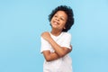 I love myself. Portrait of adorable optimistic little boy with curls embracing himself and smiling Royalty Free Stock Photo