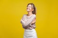 I love myself. Portrait of proud beautiful woman with fair hair in casual beige blouse, isolated on yellow background Royalty Free Stock Photo