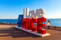 I love Nice sign at Quai Rauba Capeu seashore promenade below Colline du Chateau Castle Hill at French Riviera in France Royalty Free Stock Photo