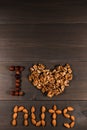 I love nuts, Inscription from nuts, walnuts, almonds and hazelnuts. Vertical frame Royalty Free Stock Photo