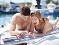 I love this photo. Young couple looking at their holiday snapshots while relaxing on a yacht. Royalty Free Stock Photo