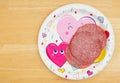 I love salami message with sliced salami on a festive heart plate