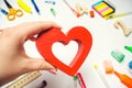 I Love School! the student holds the heart in his hands on the background of the desk. love of learning. school supplies. statione