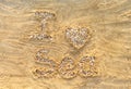 I love sea. Letters and heart made from small stones and seashells on sea sand. Royalty Free Stock Photo