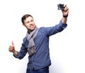 I love selfie! Handsome young man in shirt holding camera