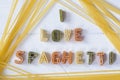 I love spaghetti text written with pasta letters font on white wooden background