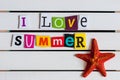 I Love Summer - written with color magazine letter clippings on wooden board. Travel concept