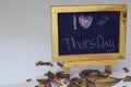 I love Thursday written on a chalkboard. Autumn seasonal flat lay photo on White background