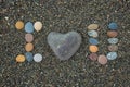 I love U made from stones on sandy beach. Royalty Free Stock Photo