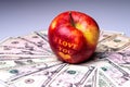 I love You apple with heart on dollar banknotes. The concept of love and prosperity. Closeup Royalty Free Stock Photo