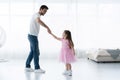 I love you, dad! Handsome young man is dancing at home with his little girl. Happy Father`s Day! Royalty Free Stock Photo