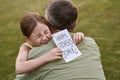 I love you, daddy. Cute happy little girl, small daughter hugging her father and giving him postcard on holiday Royalty Free Stock Photo