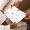 I love you, daddy. Little girl giving postcard to father