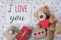 I love you. Greeting card Valentine. Declaration of love. Teddy bear with a heart and boxes with gifts. View from above Royalty Free Stock Photo