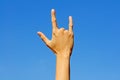 I love you in hand sign language on blue sky background. Royalty Free Stock Photo
