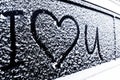 I love you Heart symbol on frozen window of the car. Shape of heart drawn on snow on front window of the car. Heart snow. Christma Royalty Free Stock Photo