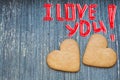 I love you inscription on grey wooden background with ginger bread biscuits below. Saint valentines frame. Love and