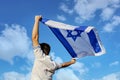 I love you Israel, concept. A young Israeli man, loving Israel, raised the flag of Israel to the sky above his head Royalty Free Stock Photo