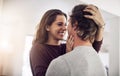 I love you more. an affectionate young couple hugging in the kitchen at home. Royalty Free Stock Photo