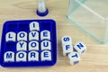 I LOVE YOU MORE on Wording Game Royalty Free Stock Photo